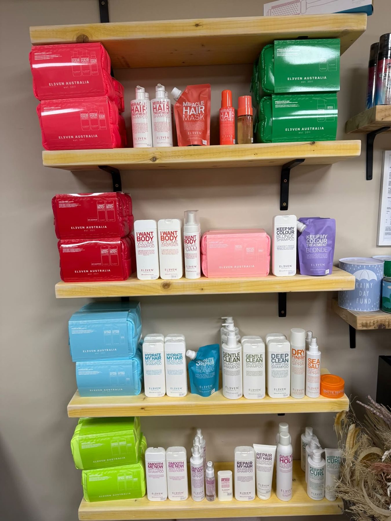 Shelves of ELEVEN Australia shampoos, treatments and masks in the salon