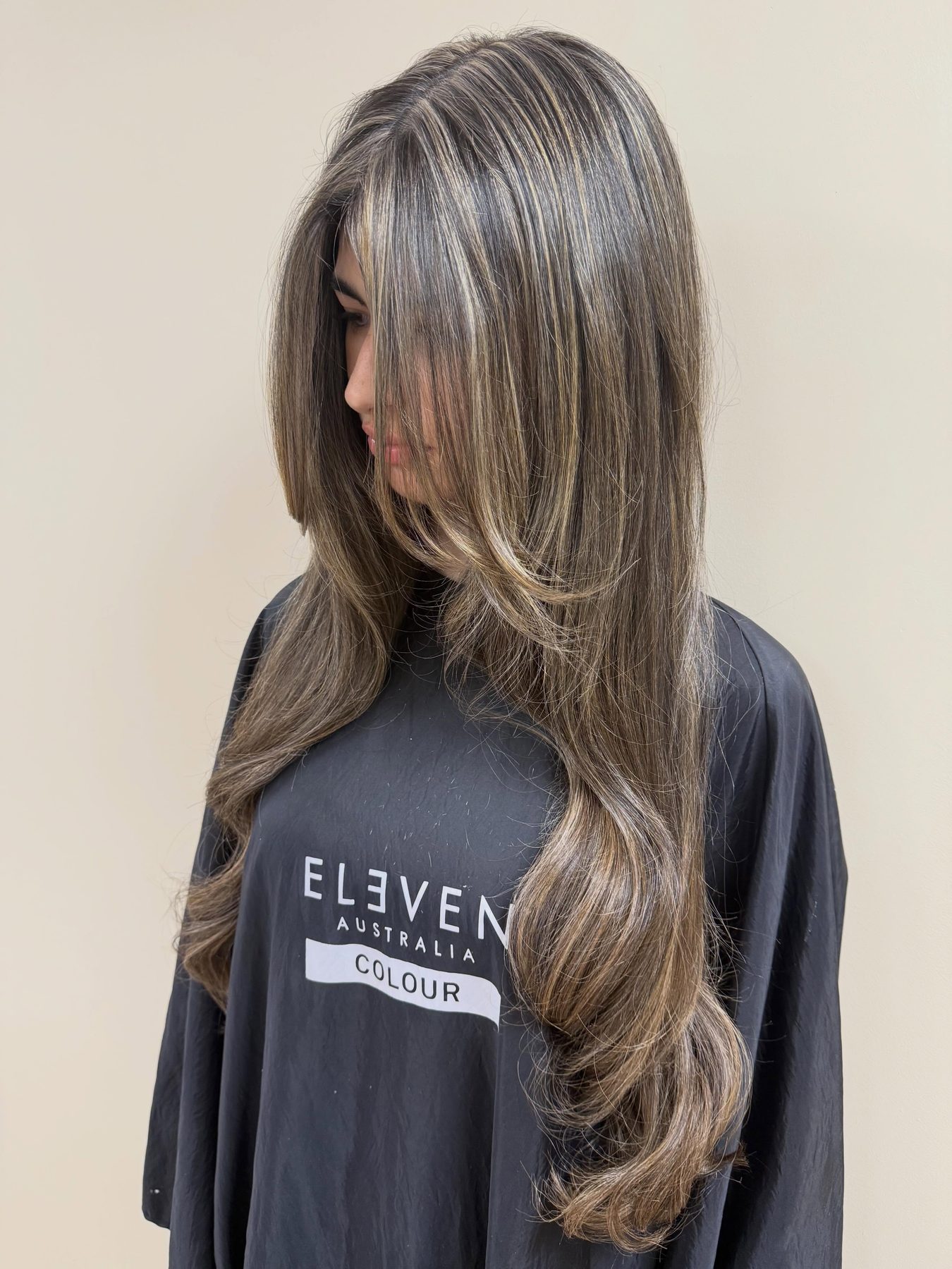 Long, lightened brunette hair with soft face framing, finished in the salon