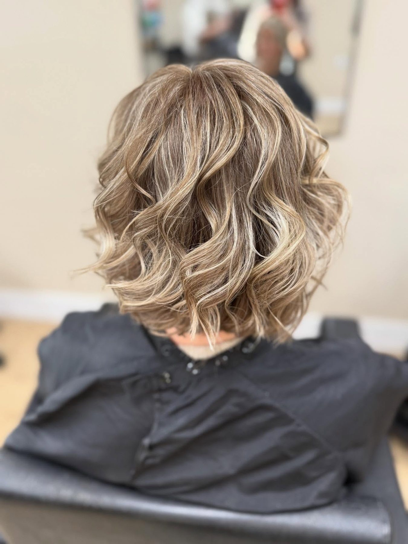 Curly bob with soft baby lights, seen from behind
